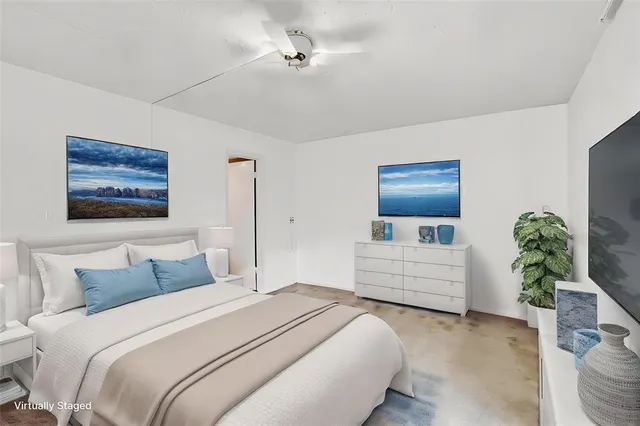 a bedroom with bed potted plant and a window
