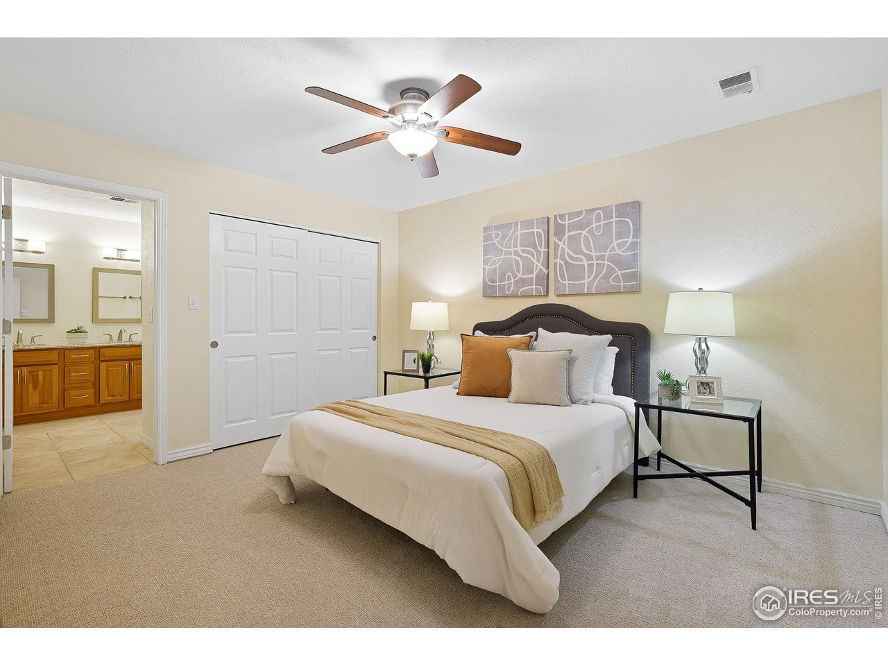 1303 Alpine Avenue, Unit 24 Boulder, CO 80304 - Photo 16 of 46 a bedroom with a bed and a chandelier