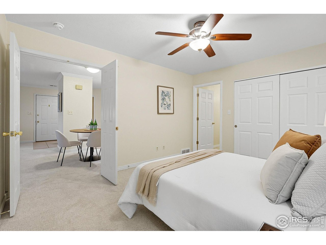 1303 Alpine Avenue, Unit 24 Boulder, CO 80304 - Photo 17 of 46 a bedroom with a bed and a chandelier