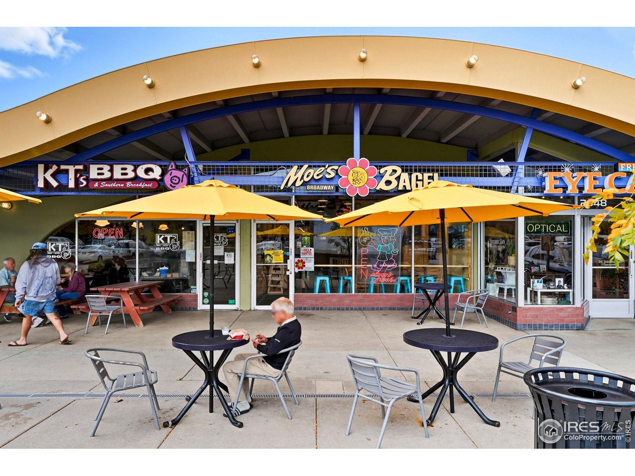 1303 Alpine Avenue, Unit 24 Boulder, CO 80304 - Photo 40 of 46 a view of a cafe with a table and chairs under an umbrella