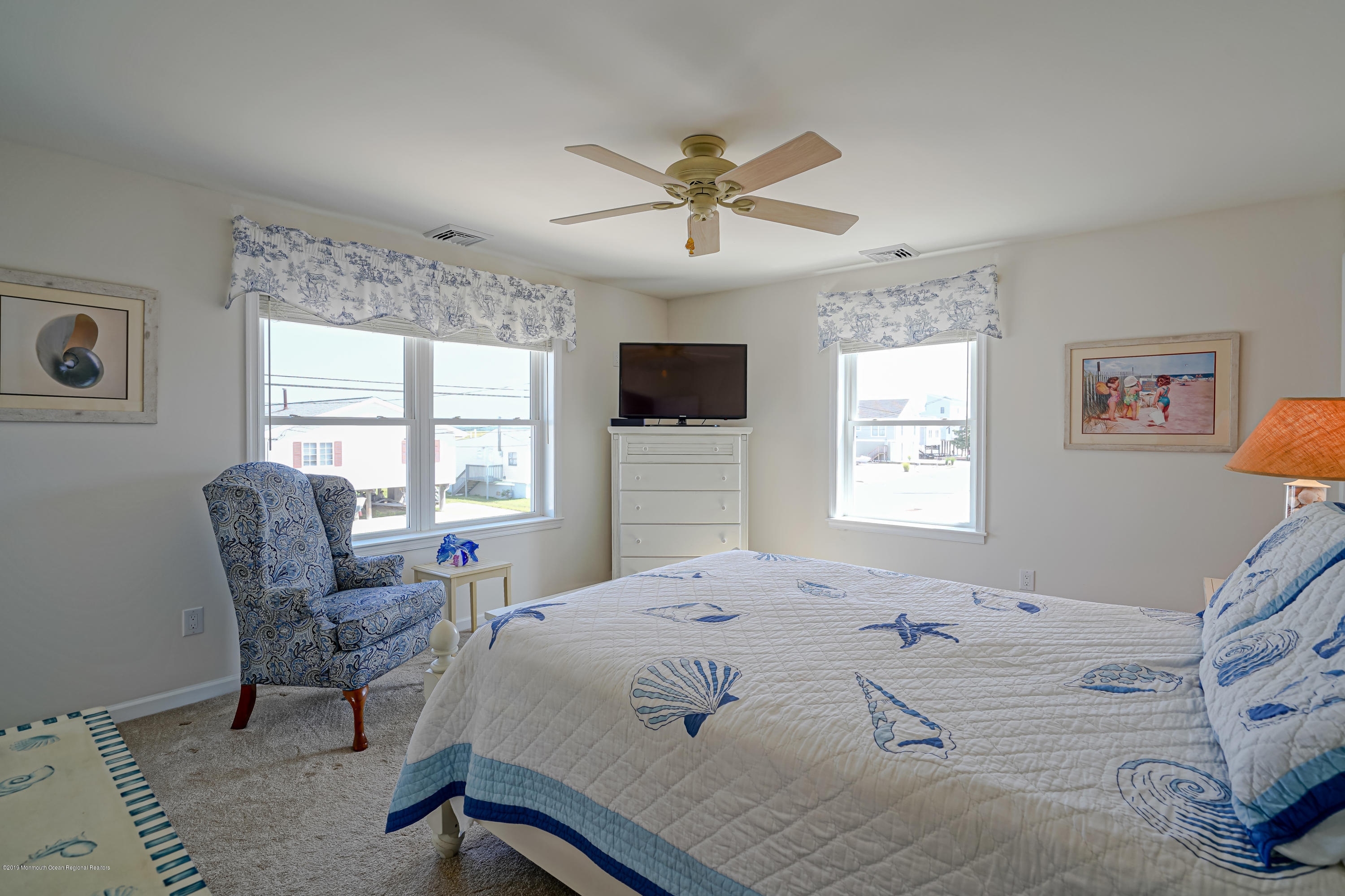 341 Kingfisher Road Tuckerton, NJ 08087 - Photo 17 of 38 a bedroom with a bed a chair and a large window