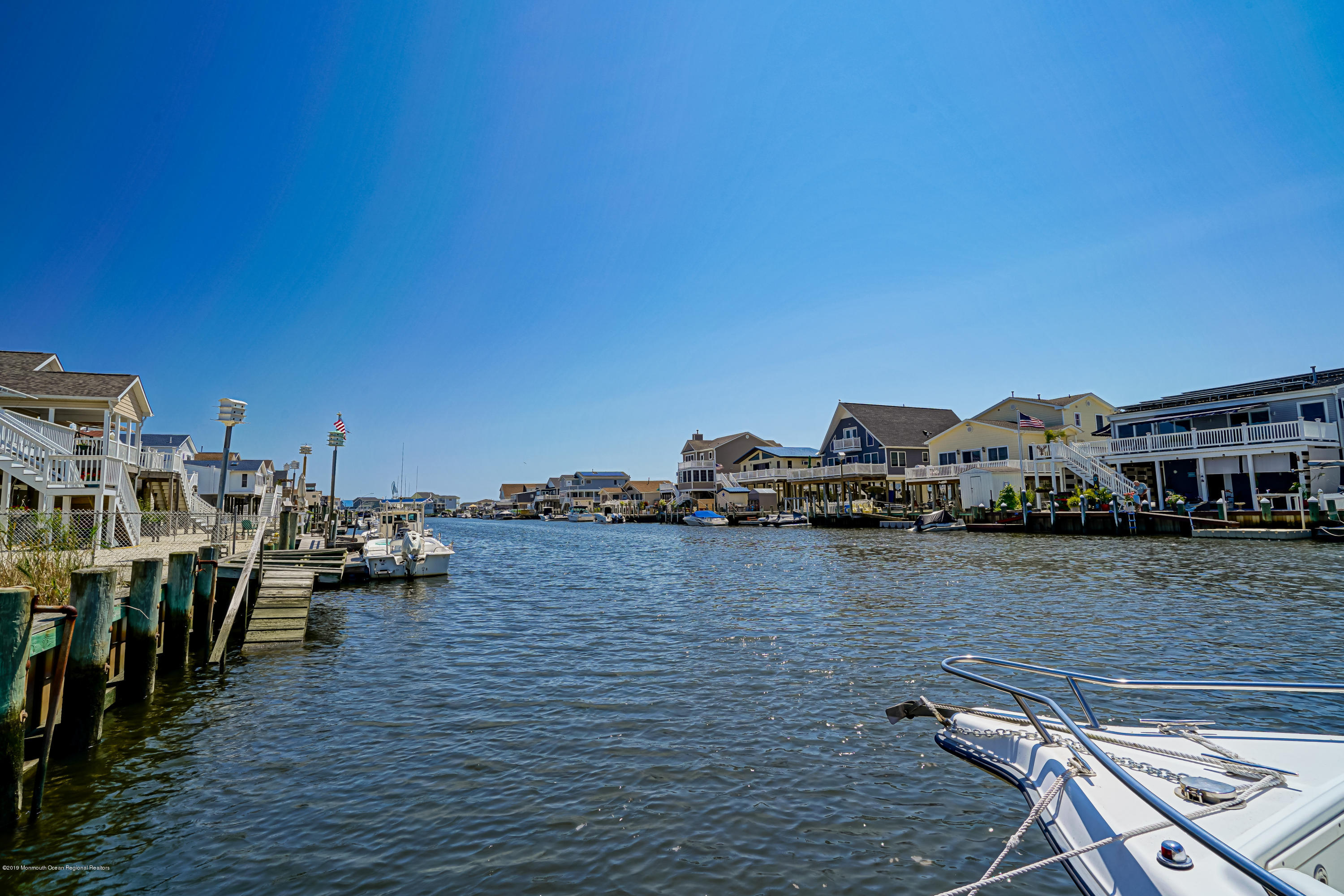 341 Kingfisher Road Tuckerton, NJ 08087 - Photo 34 of 38 a view of a ocean with boats and trees in the background