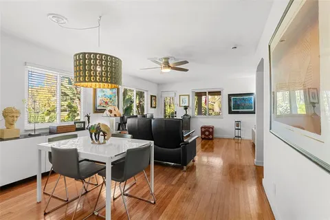 a view of a dining room with furniture window and wooden floor