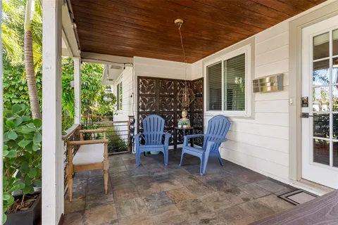 a view of a porch with chairs and couches
