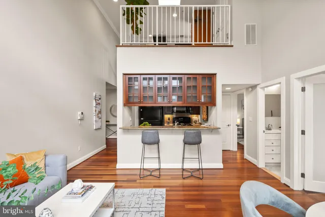 a living room with furniture and a wooden floor