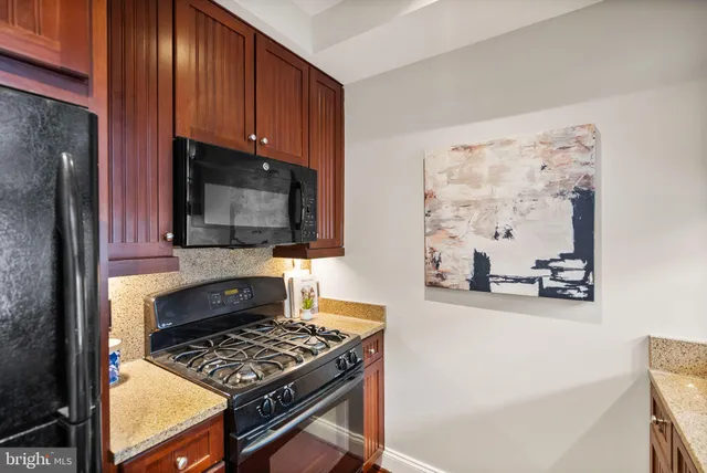 a kitchen with wooden cabinets and a stove top oven