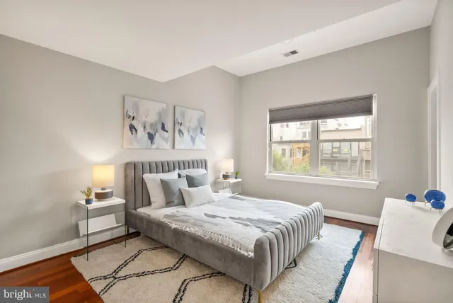 a bedroom with a large bed and a window