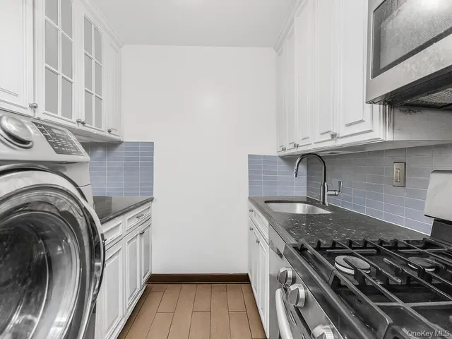 a kitchen with granite countertop a stove and a sink