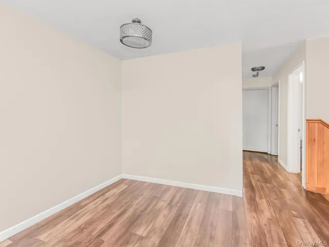 a view of a room with wooden floor and brick walls