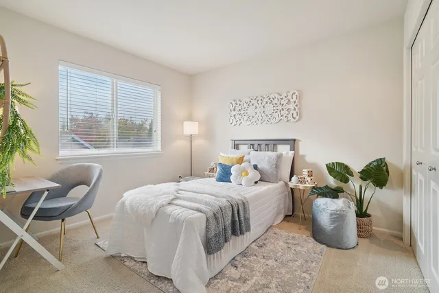 a bedroom with a bed and a window