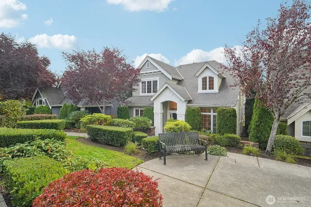 a view of a house with a yard and sitting area