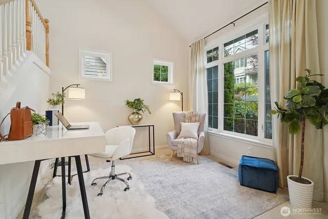 a living room with furniture and a potted plant