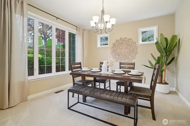 a view of a dining room with furniture and chandelier
