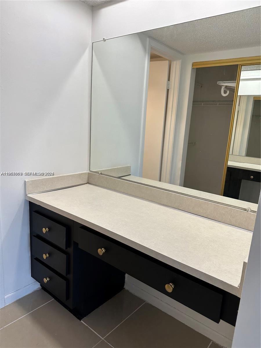 200 Ashbury Road, Unit 209 Hollywood, FL 33024 - Photo 11 of 18 a bathroom with a sink and a mirror