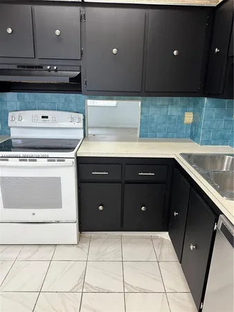 a kitchen with a sink and cabinets