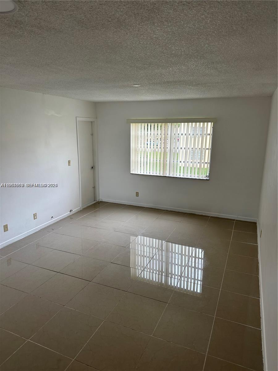 200 Ashbury Road, Unit 209 Hollywood, FL 33024 - Photo 7 of 18 a view of an empty room and window