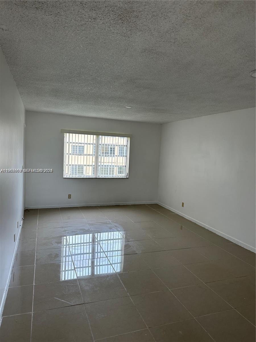 200 Ashbury Road, Unit 209 Hollywood, FL 33024 - Photo 8 of 18 a view of an empty room and window