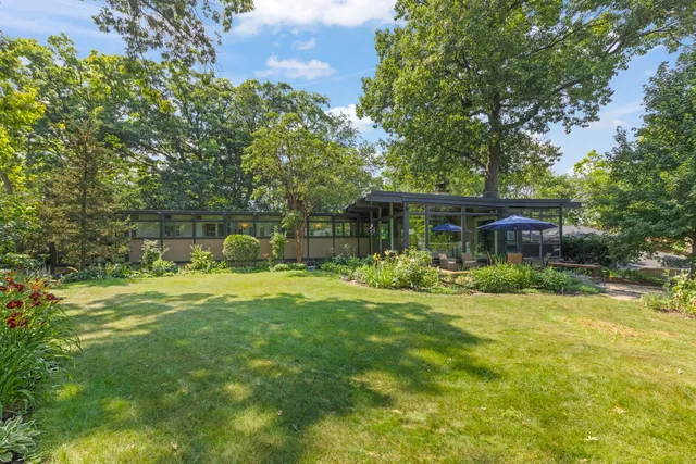 a front view of a house with a yard table and chairs