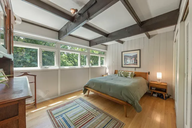 a bedroom with a bed and a window