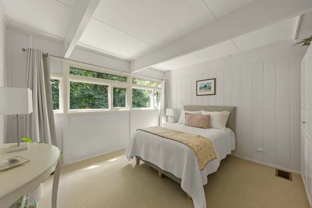 a bedroom with a bed and a window