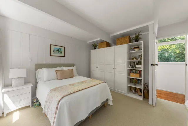 a bedroom with a bed and a walk in closet