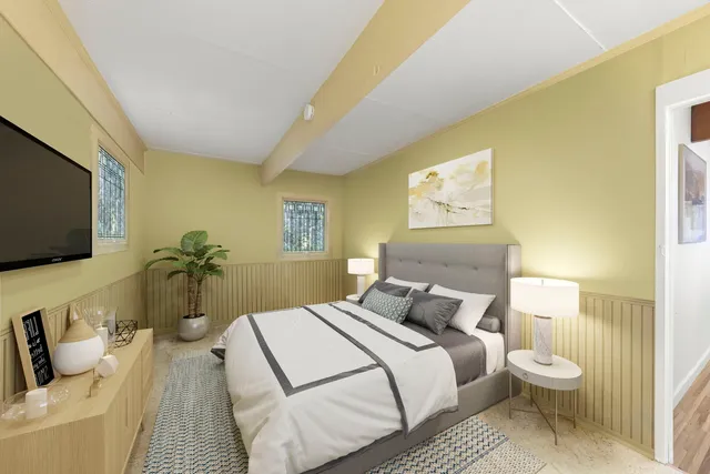 a bedroom with a bed and a flat screen tv