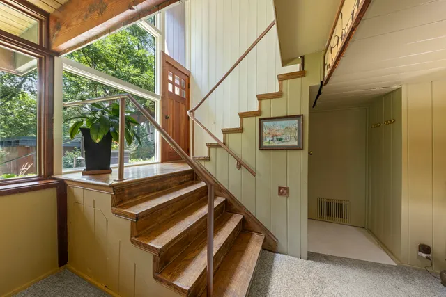 a view of entryway and hall with wooden floor