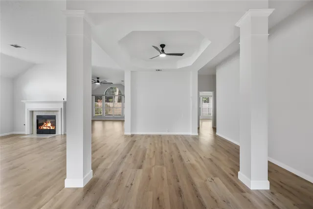 wooden floor in an empty room with a window