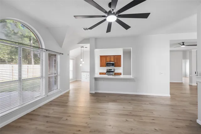wooden floor in an empty room with a window