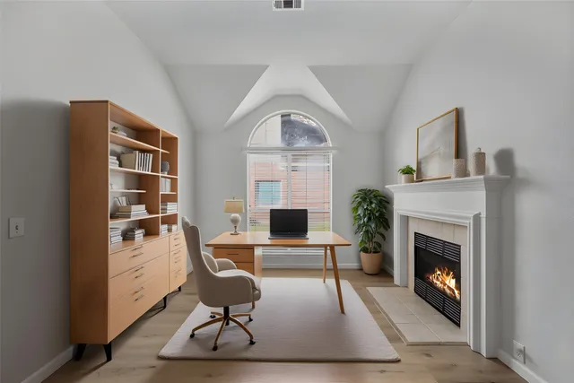 a living room with furniture a fireplace and a table