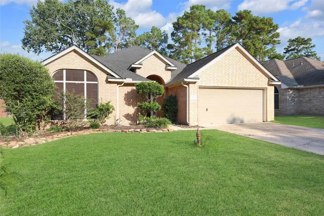 a view of house with backyard and garden