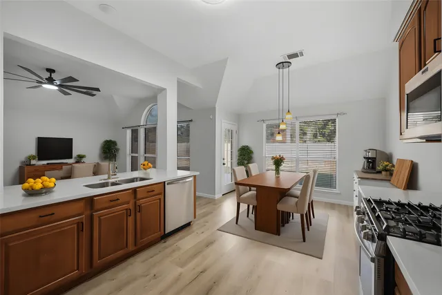 a work room with furniture a flat screen tv and a window