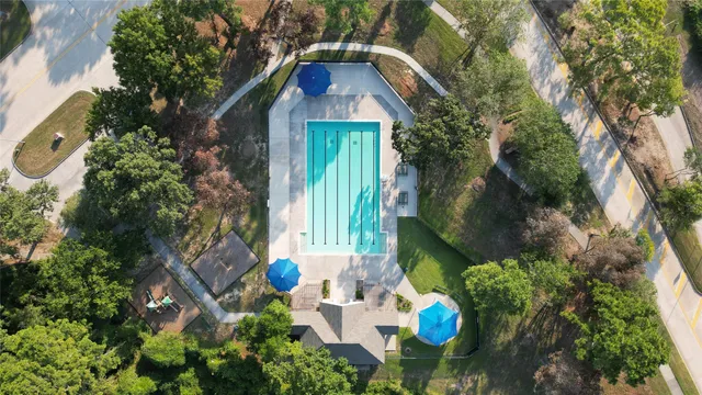 a view of a house with a small yard and large tree