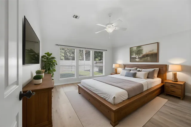 a bedroom with bed and a window