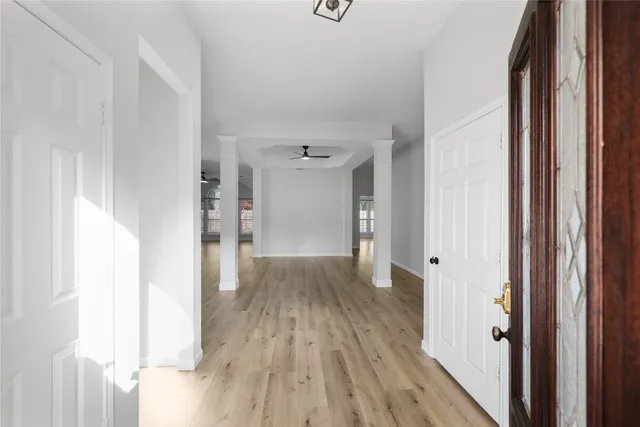 a view of a hallway with wooden floor