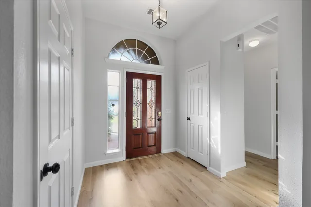 a view of an entryway with wooden floor
