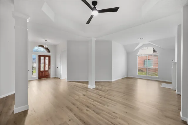 wooden floor in an empty room with a window