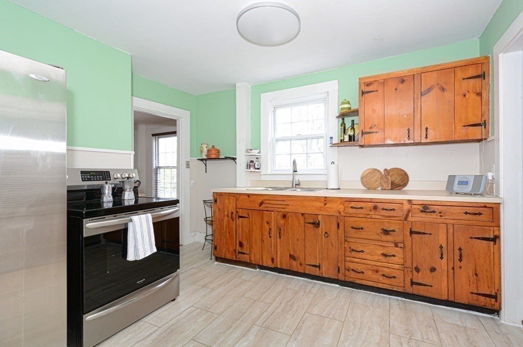 8 Myrtle Street Westborough, MA 01581 - Photo 12 of 35 a kitchen with stainless steel appliances granite countertop a stove a sink and a refrigerator