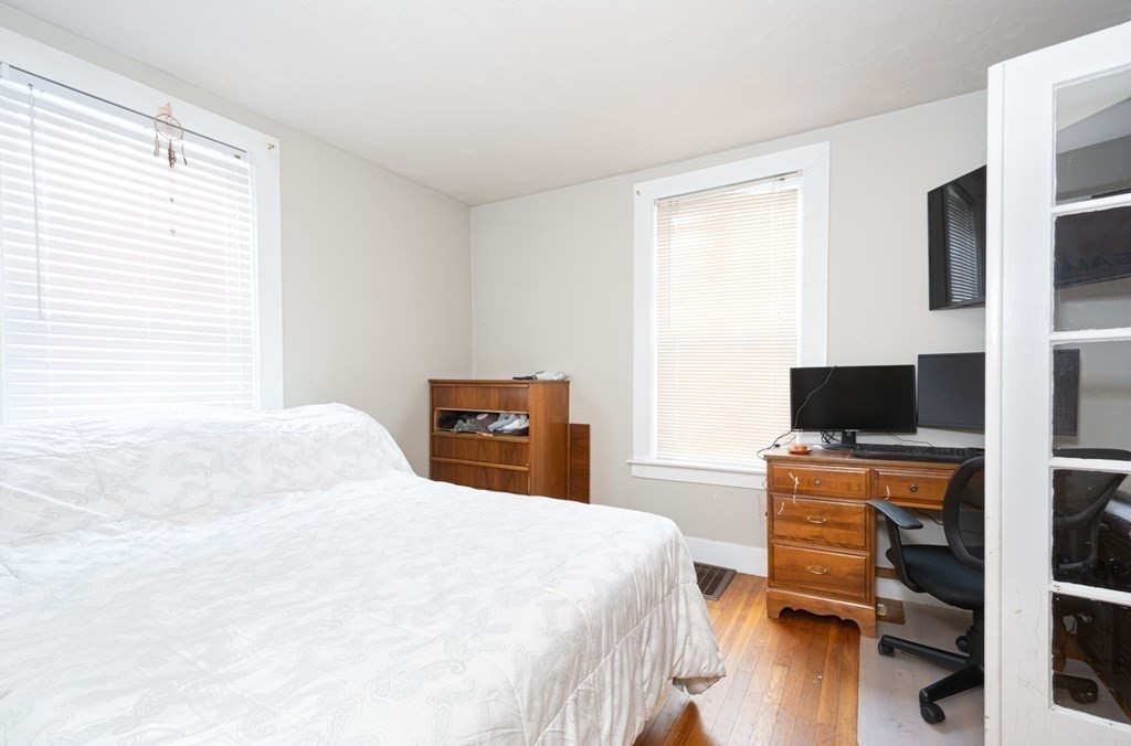 8 Myrtle Street Westborough, MA 01581 - Photo 8 of 35 a bedroom with a bed and a chair