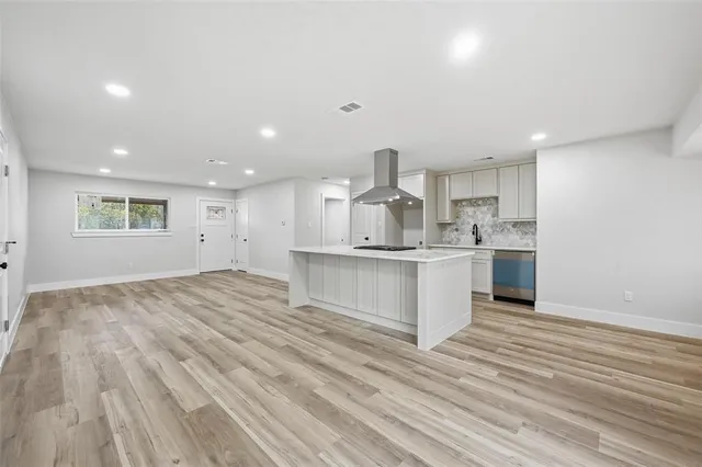 a view of kitchen wooden cabinets and wooden floor