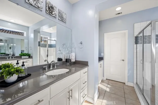 a bedroom with a bed and large windows