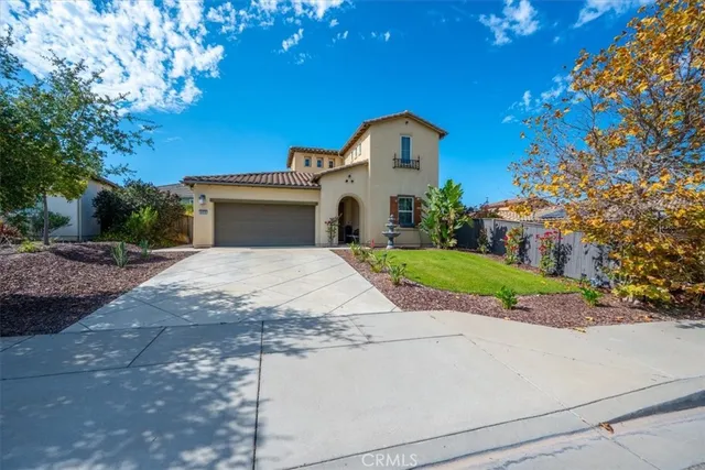 a view of a house with a yard and large tree