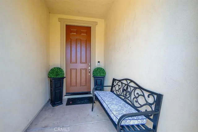 a view of a hallway with wooden floor and a potted plant