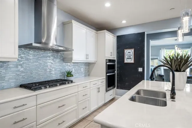 a kitchen with stainless steel appliances kitchen island granite countertop a stove a sink a microwave and a refrigerator