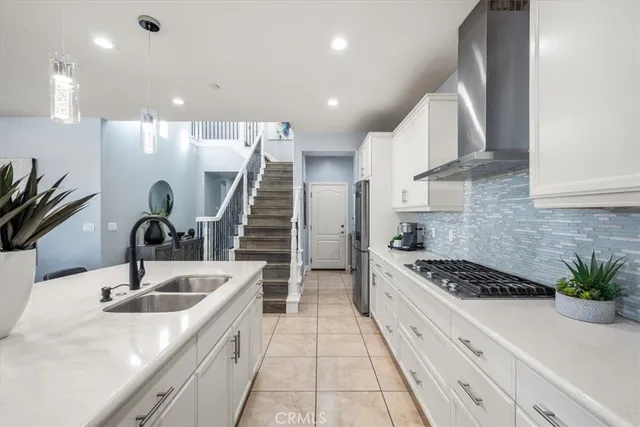 a kitchen with granite countertop a sink a stove and cabinets