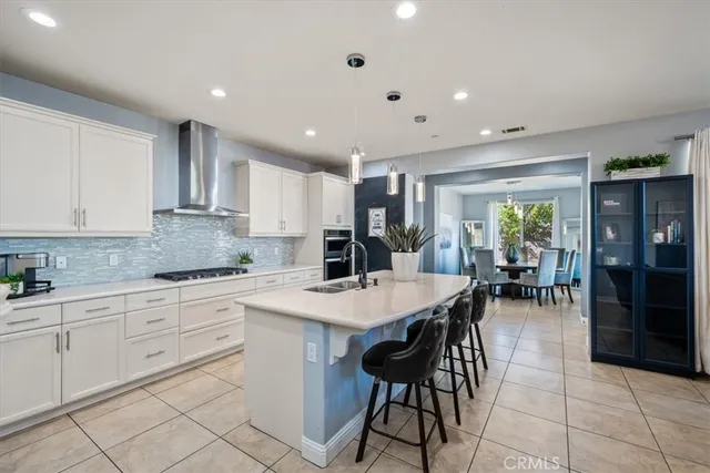 a kitchen with granite countertop a sink stainless steel appliances and cabinets