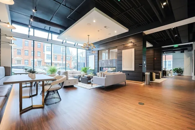 a living room with furniture and large windows