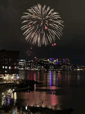 a view of swimming pool outdoor seating and city view