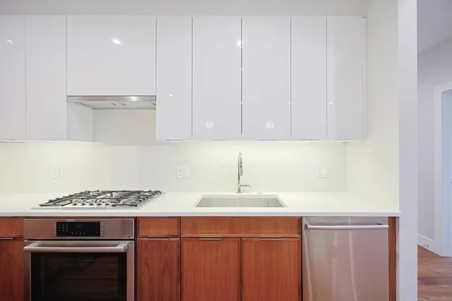 a kitchen with a sink stove and cabinets