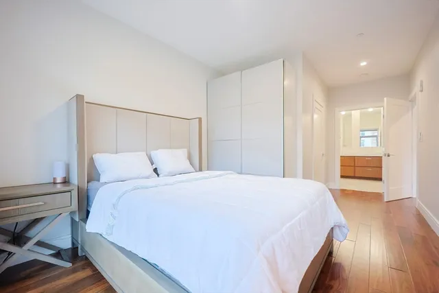 a bedroom with a bed and a view of kitchen
